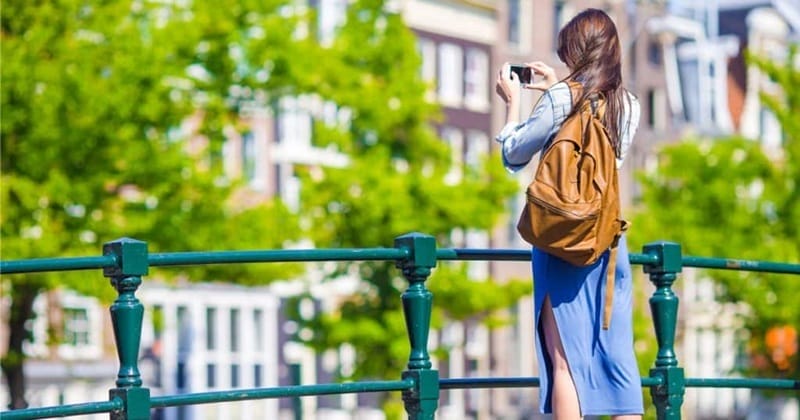 Woman using cell phone in Amsterdam